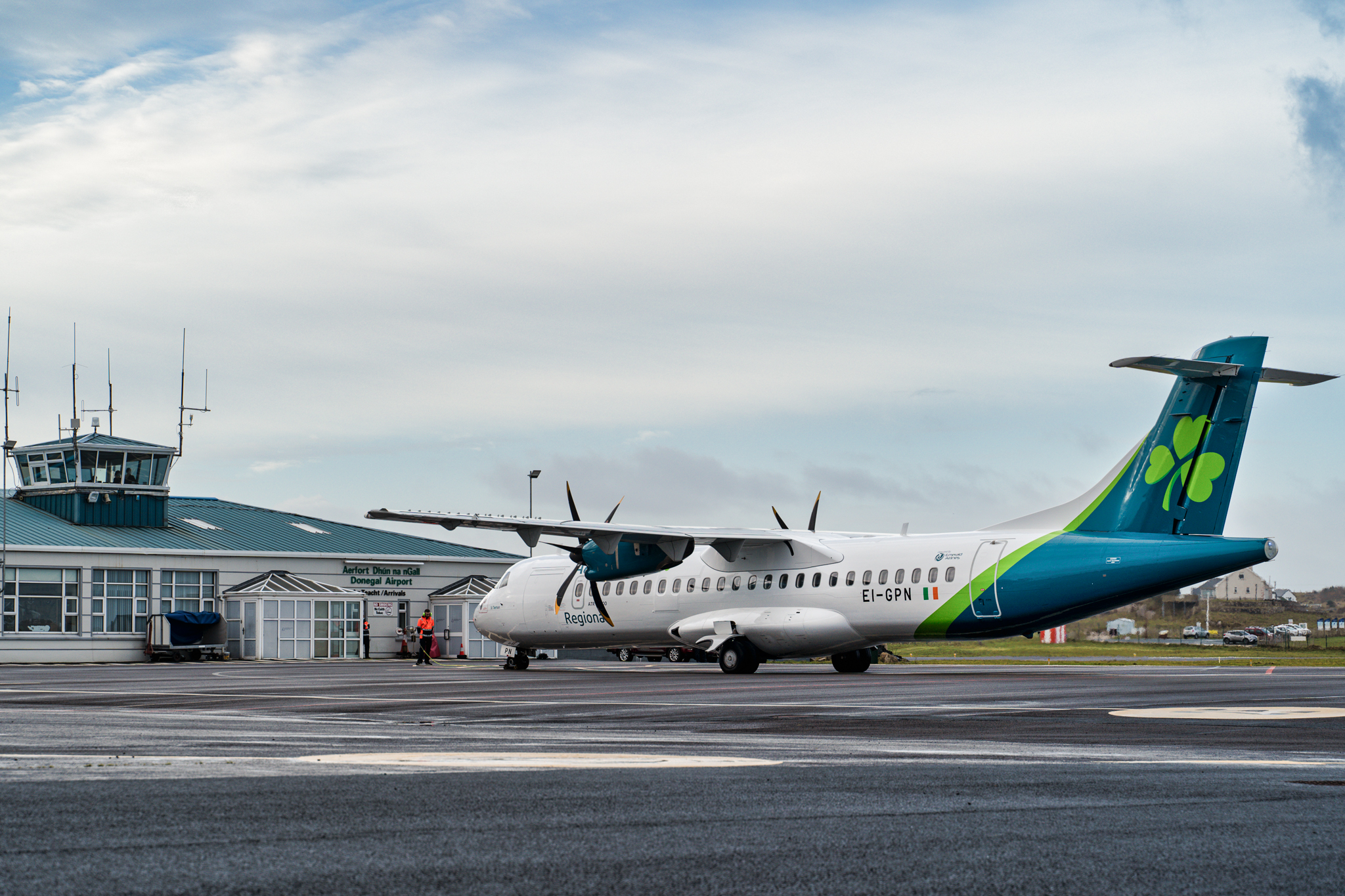 ATR-72 aircraft on Donegal Airport apron with Aer Lingus logo on the tail and the airport terminal in the background